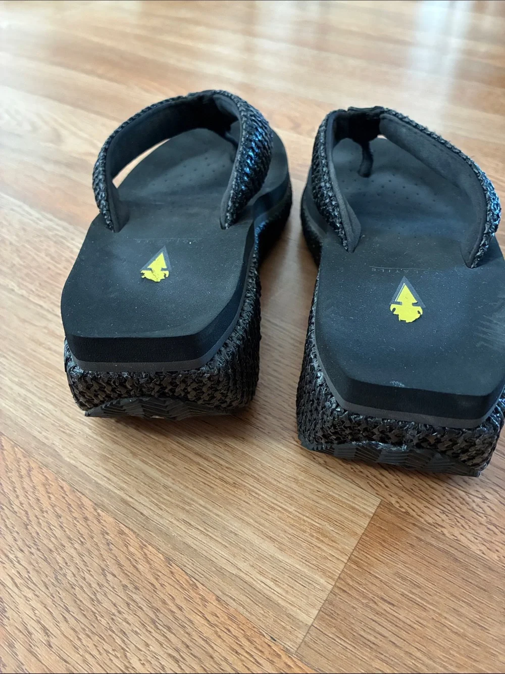 Volatile Black Braided Strap Thong Sandals with Yellow Logo